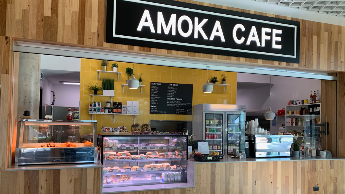 Amoka Café, which is indoors with tables and chairs at the front.