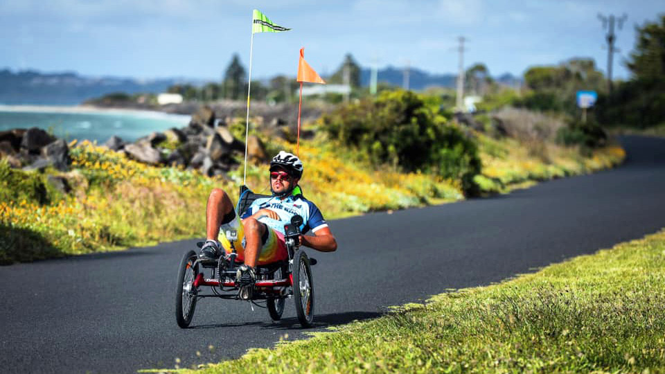 Tommy Quick riding his recumbent bicycle