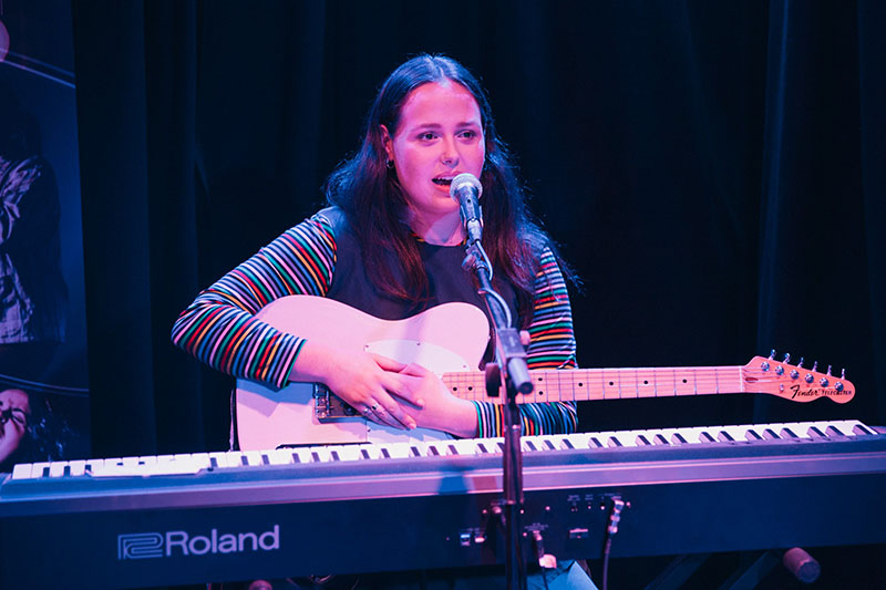 Maddie Jackway performing on the guitar.