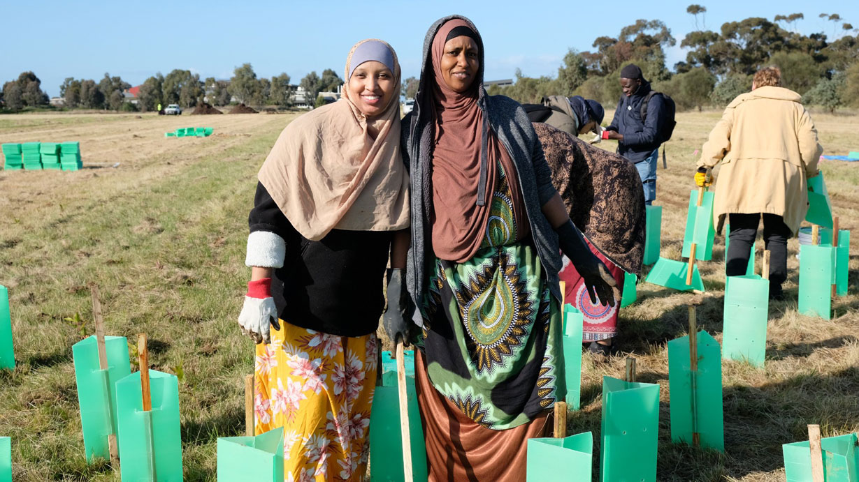 Two women planting trees at the community tree planting day 2022