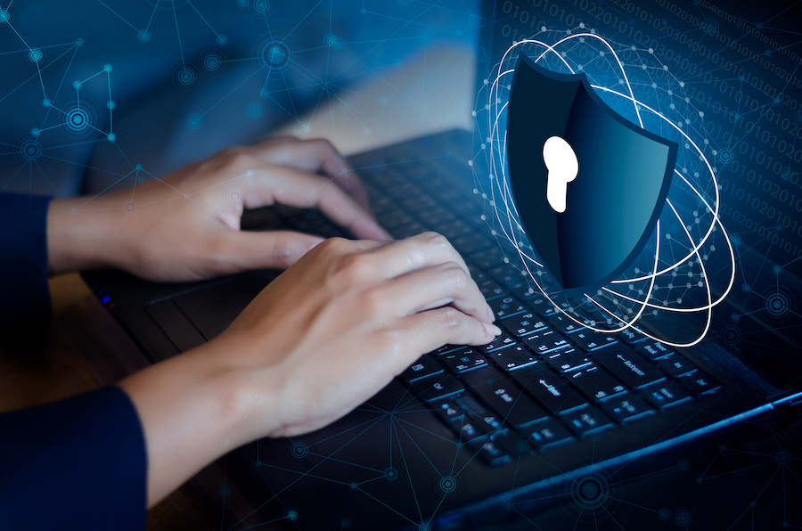 Typing on a laptop with lock graphic over the top.