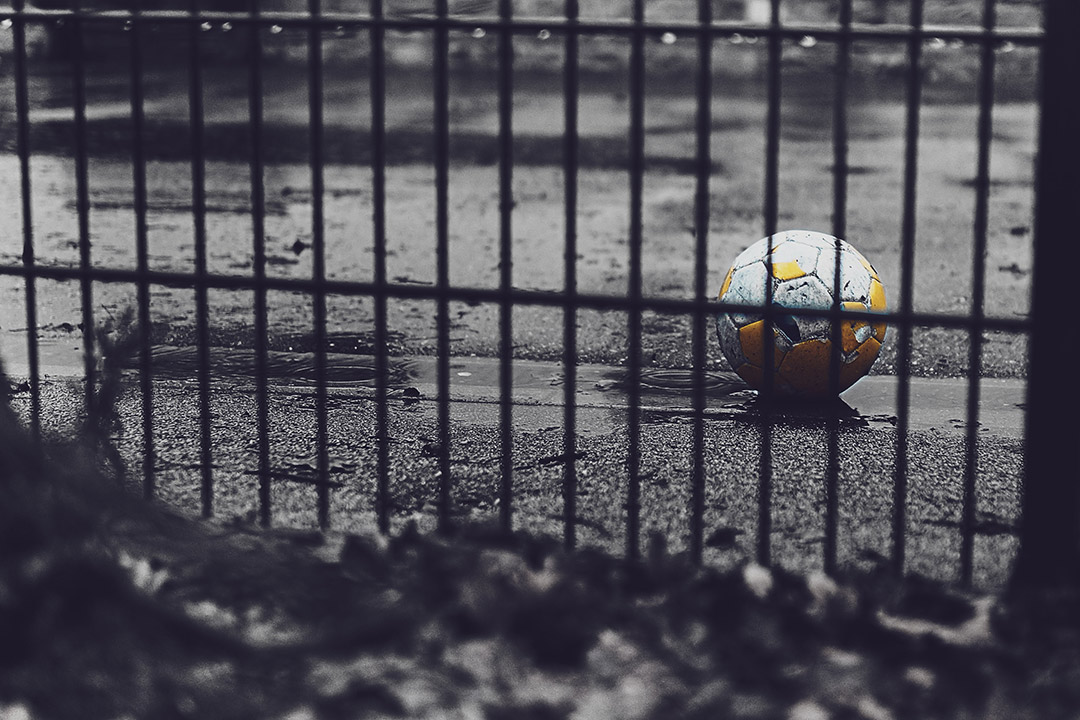 a soccer ball in a grey rainy playground