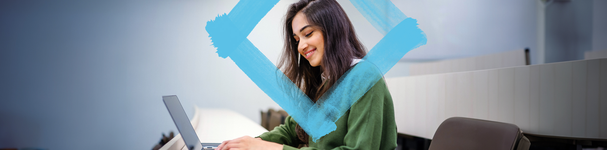 Student at computer with VU branded blue diamond in focus