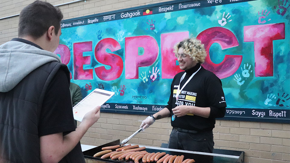 VU Vollie BBQs food for Ofest in front of the 'Respect' mural