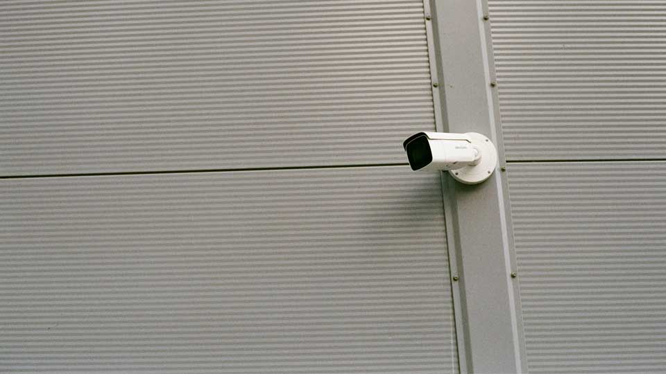 Abstract image of a surveillance camera on a wall
