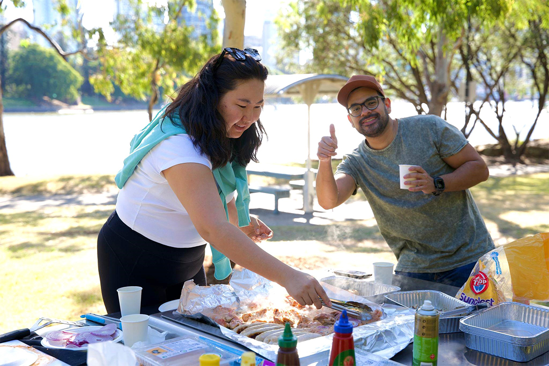 Two people enjoy a barbecue outside