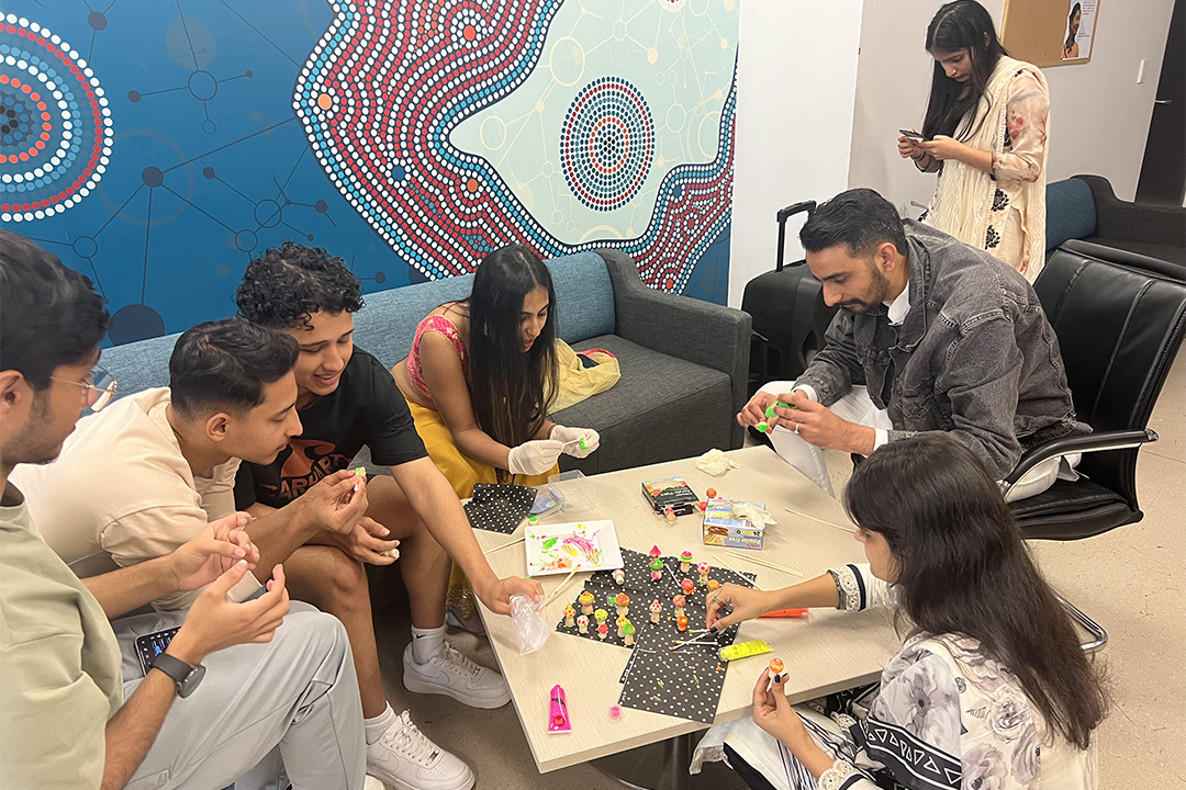 A group of people play with crafts.