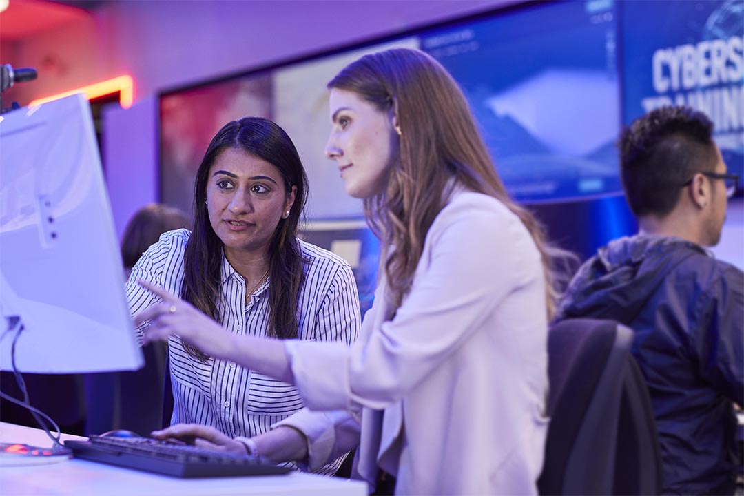 Student and teacher at VU's cyber security facility at St Alban's.