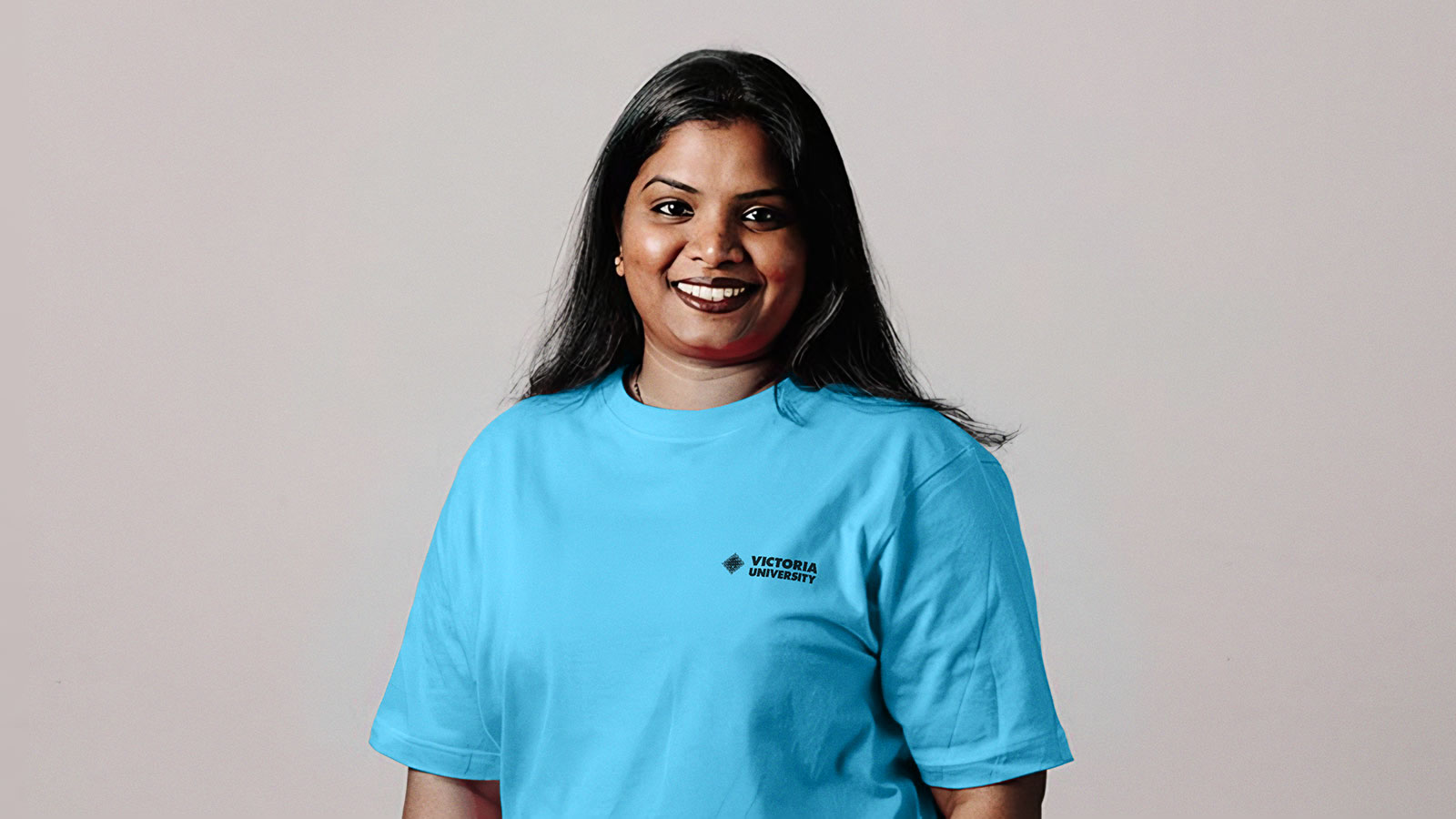 Woman in blue t-shirt with Victoria University logo