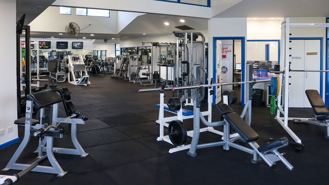 An empty gym area with various equipment.