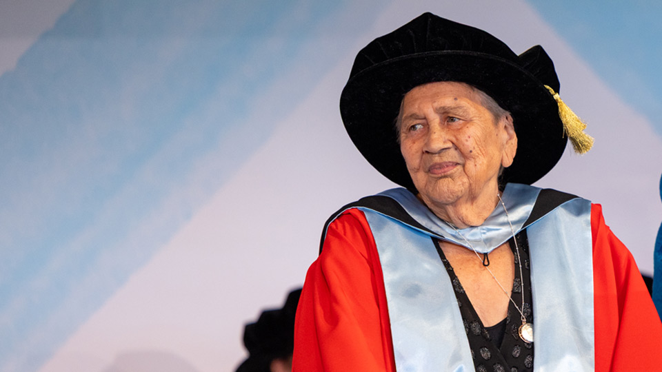 Dr Alma Thorpe receives her Doctorate onstage at the graduation ceremony