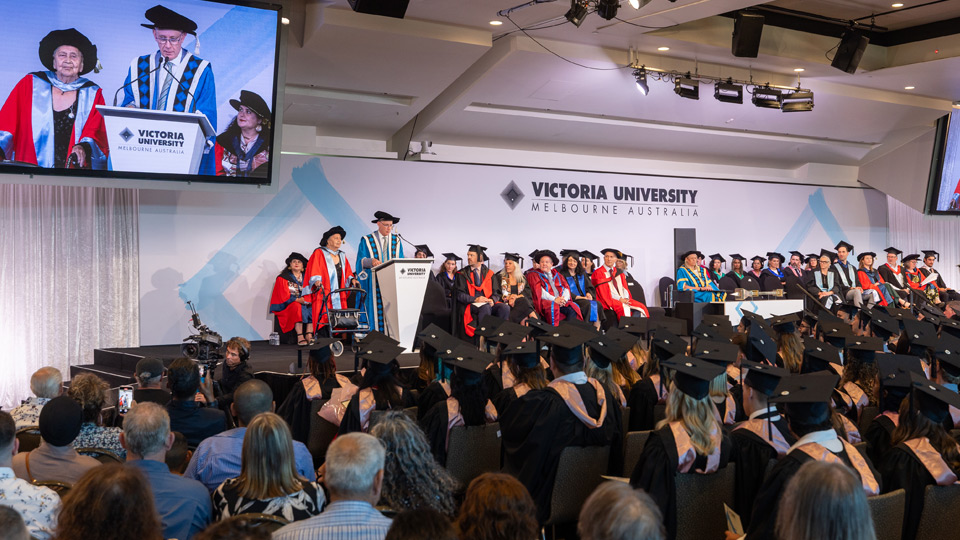 Dr Alma Thorpe receives her Honorary Doctorate onstage, Professor Adam Shoemaker reads her award citation