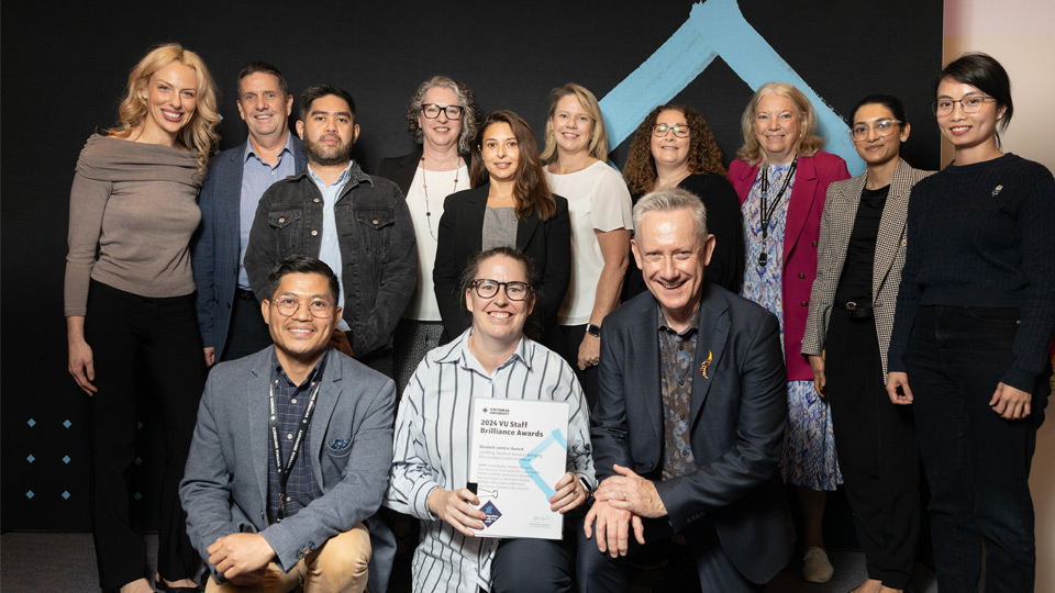 12 people smile at the camera