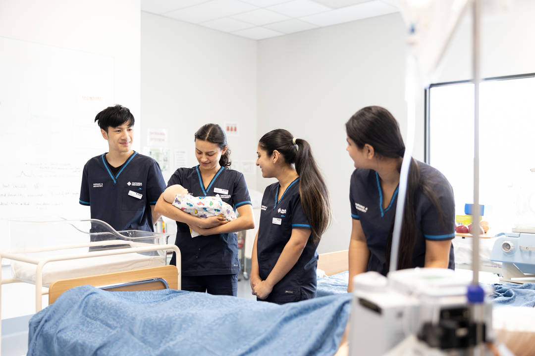 Nursing students participating in a birthing simulation