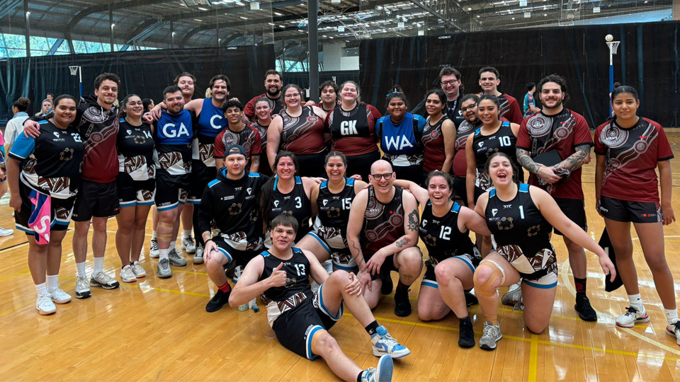 The squad with another university team after a game of netball at the Indigenous Nationals