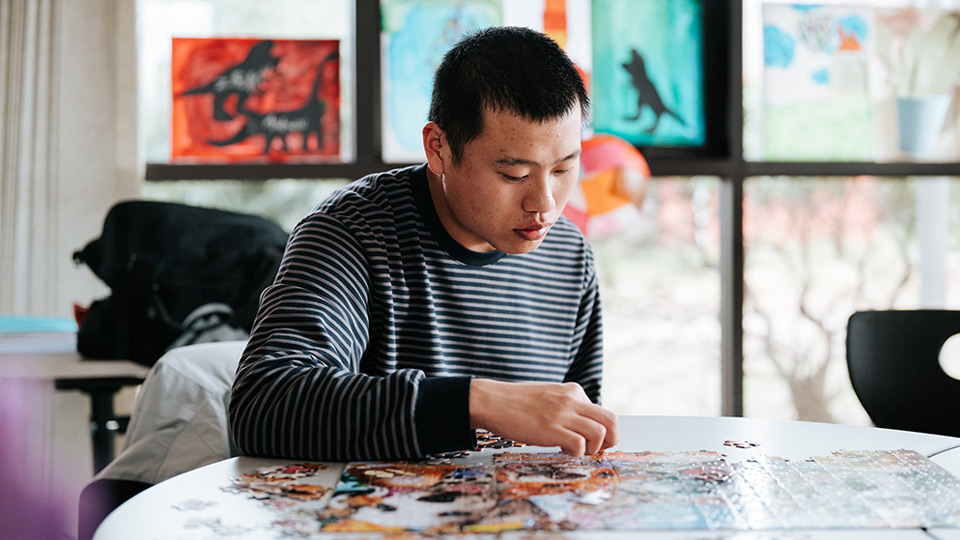 David Yong completing a puzzle