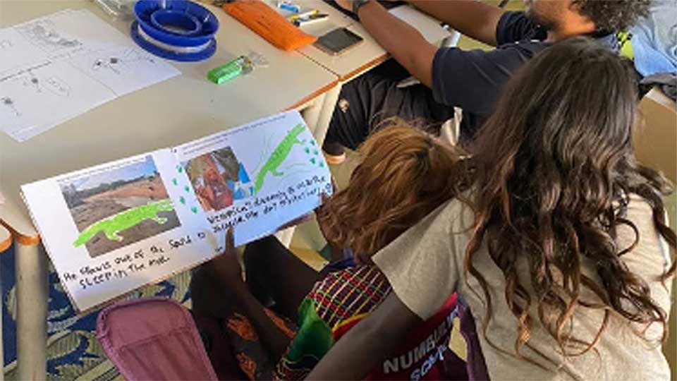 swirl school students with pre service teacher reading books in classroom