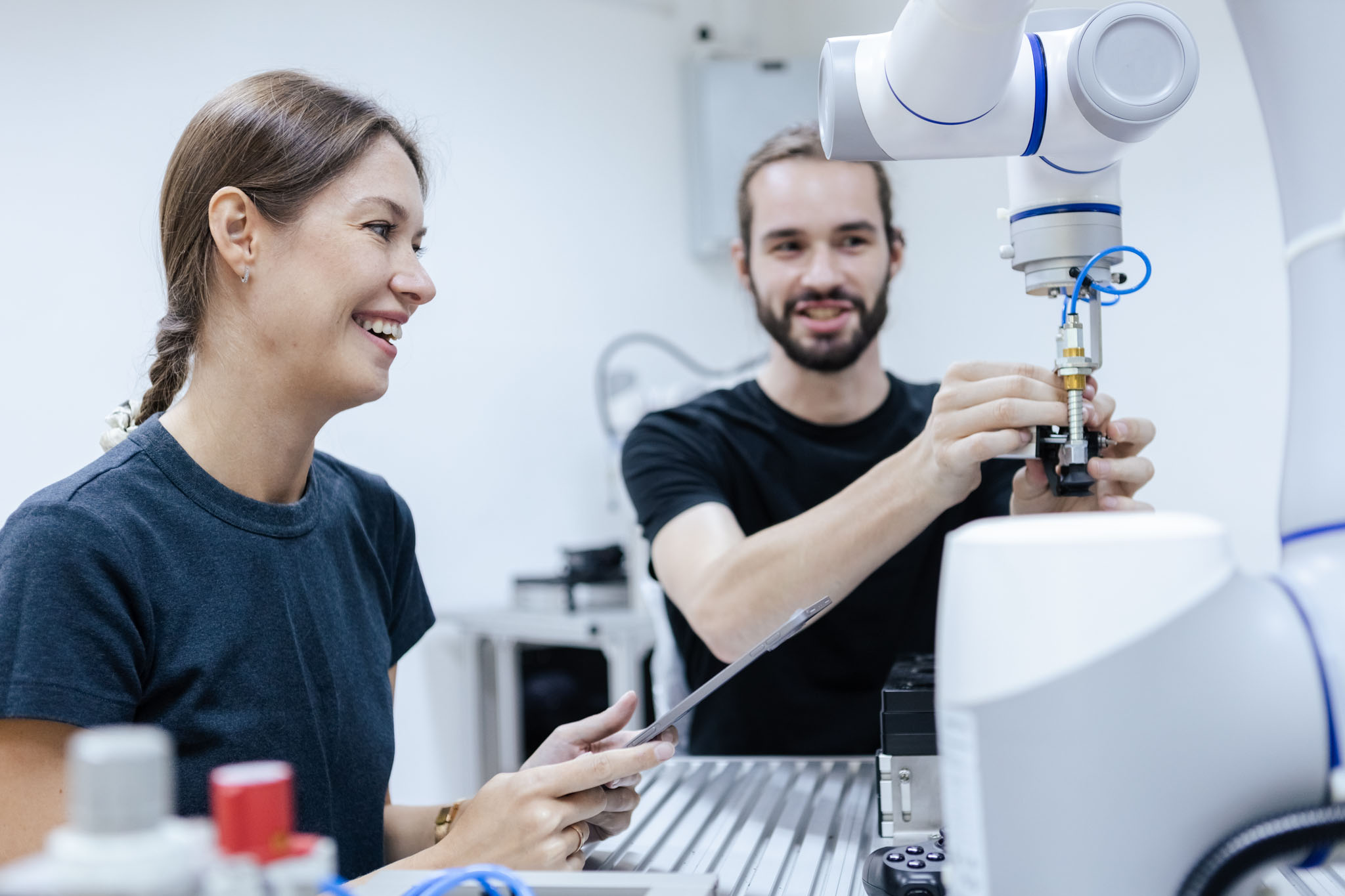 two students smiling and working in a lab together