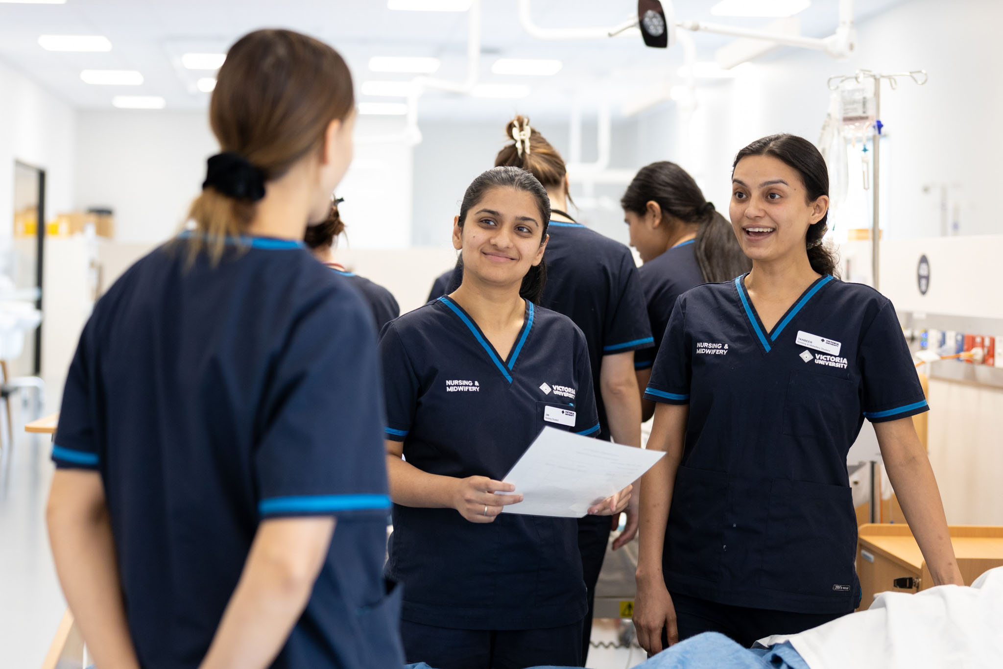 Victoria university nursing students talking to each other in lab