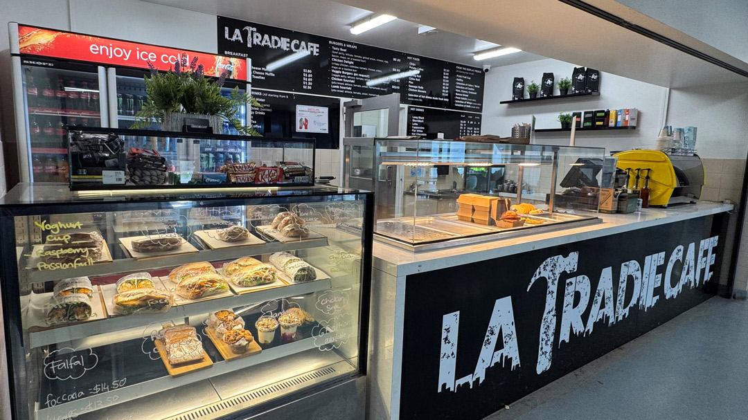 A modern campus cafe with readymade food, and La Tradie Cafe sign