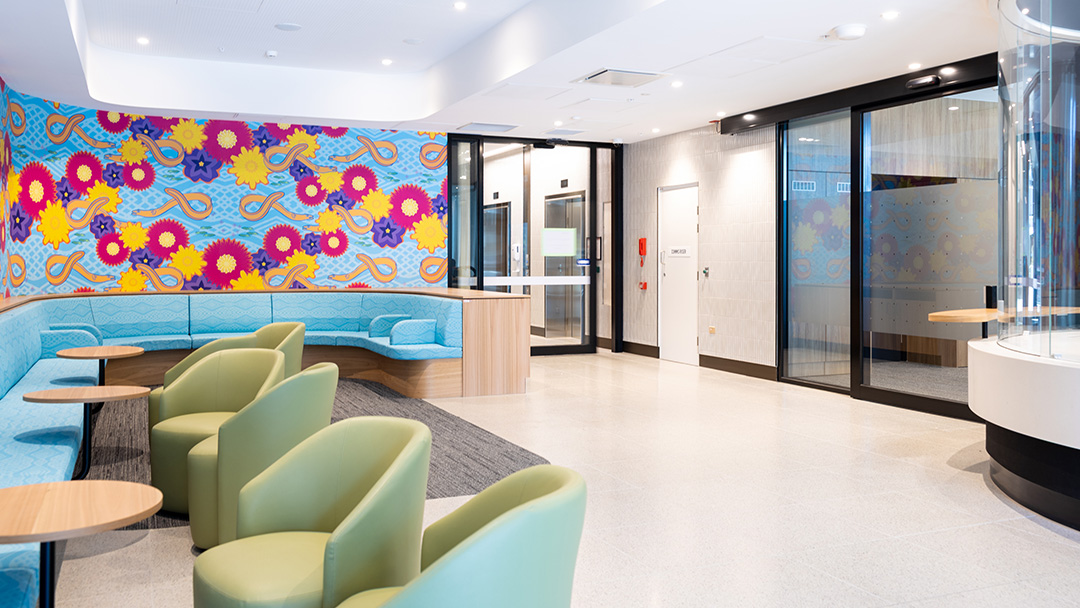 A colourful foyer with bright walls and comfortable chairs
