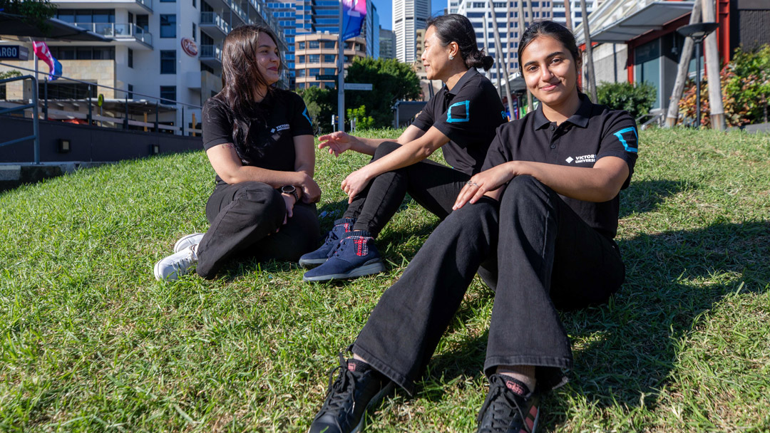 A group of students outside on a green lawn