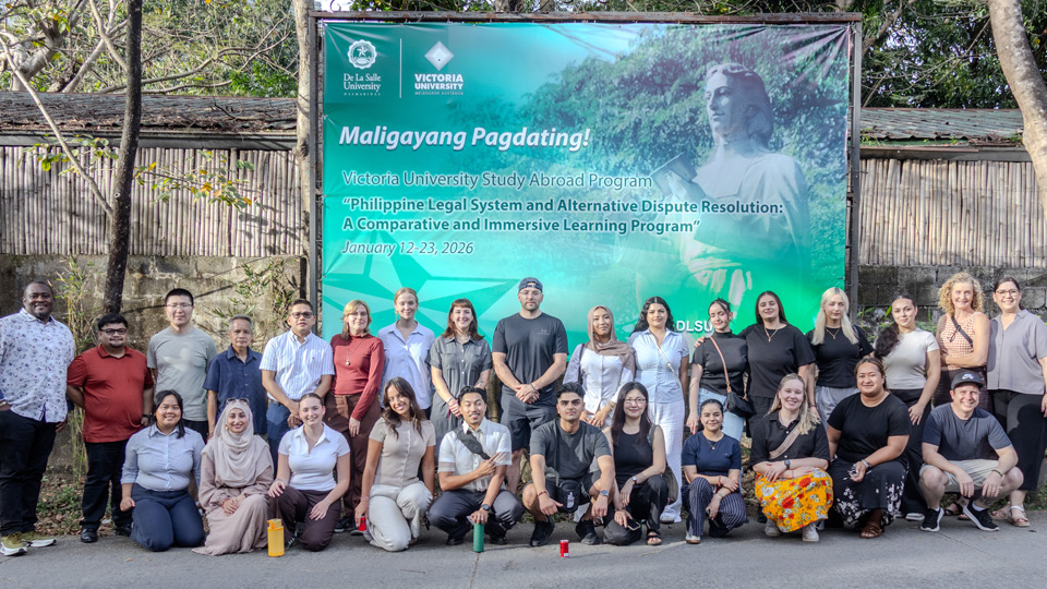The group receive a warm welcome to De La Salle University, with a welcome banner