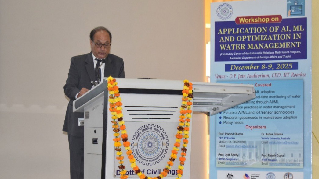 Prof. K K Pant standing behind a podium, speaking.