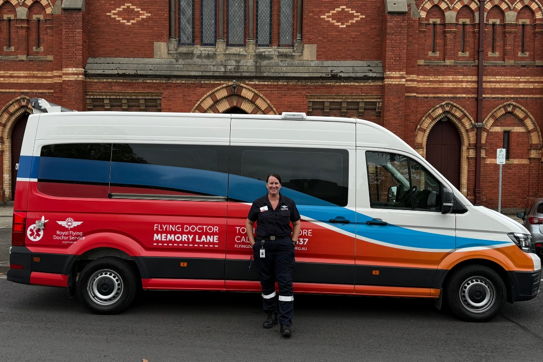 Liz Habermann standing in front of non-emergency transport vehicle