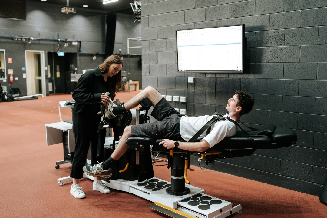 Researcher testing range of motion on a student