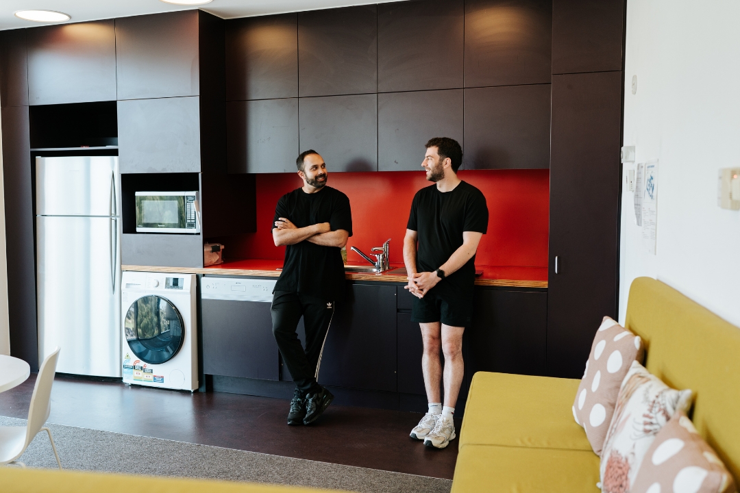 Two male research participants talking in the kitchen at the Altitude Hotel