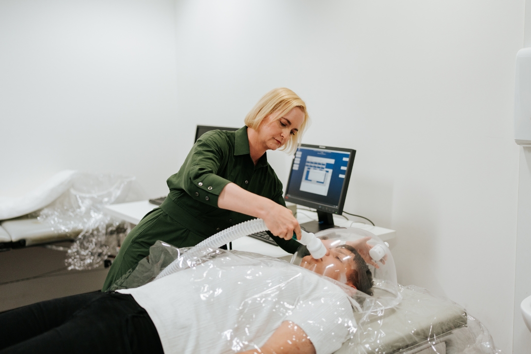 Researcher conducting oxygen test on participant