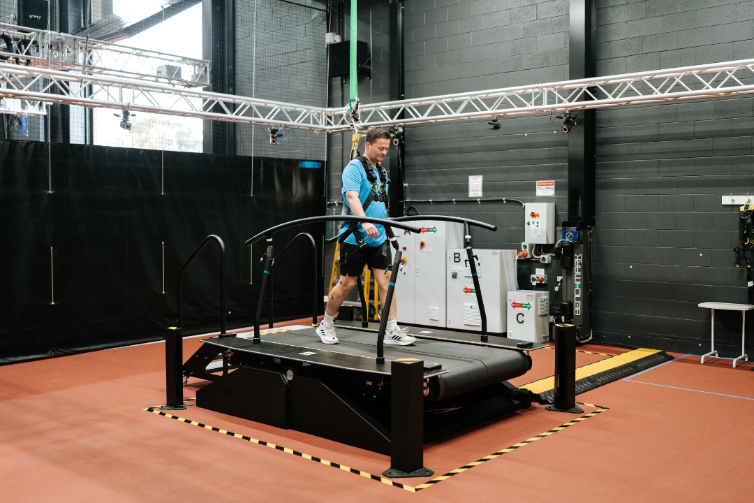 A man walks on a treadmill in the biomechanics lab for fall research