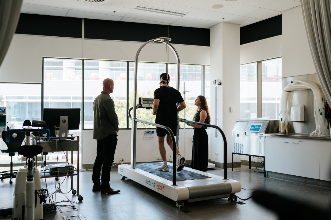 Researchers watch participant run on treadmill