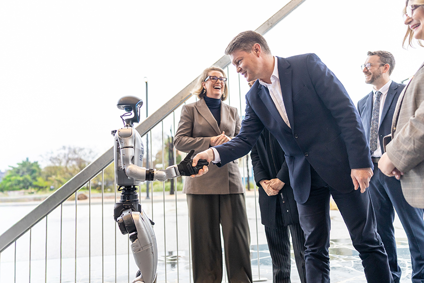 Humanoid robot shakes man's hand