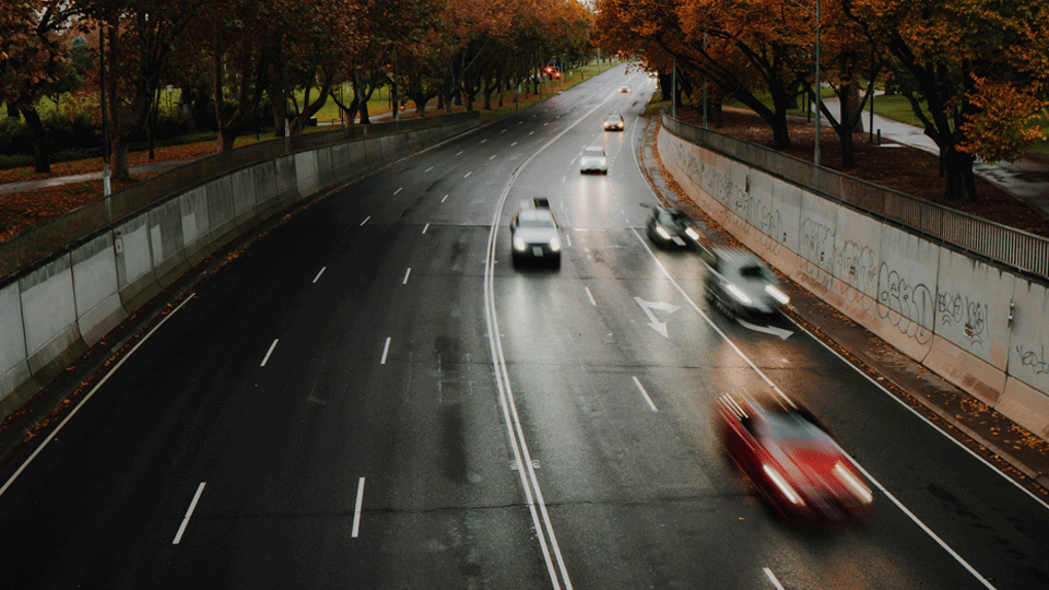 Photo of 4 lanes of Melbourne traffic on wet roads.