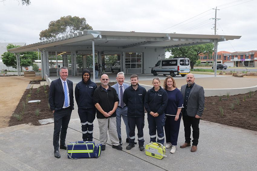 Group of people standing in front of outdoor paramedicine pavilion.