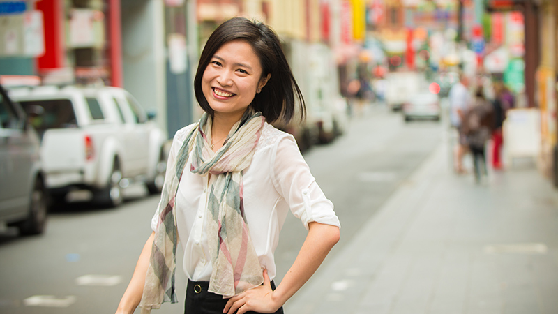 VU alumna Catherine Xiaocui Lou smiles while walking in the city