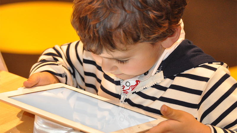 Small boy looking at an i-pad