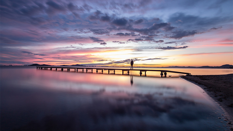 sunset, jetty, person in the distance