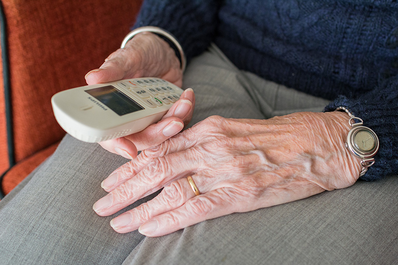 elderly hands hold phone