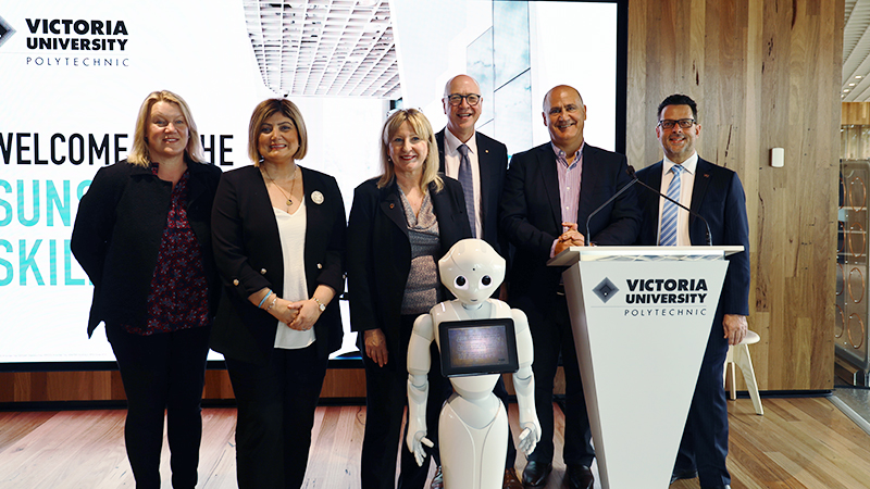 VU staff with robot at Sunshine Skills Hub opening