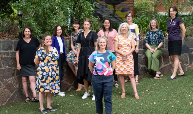 A group of people, members of VU RISE, stand together, posed and smiling.