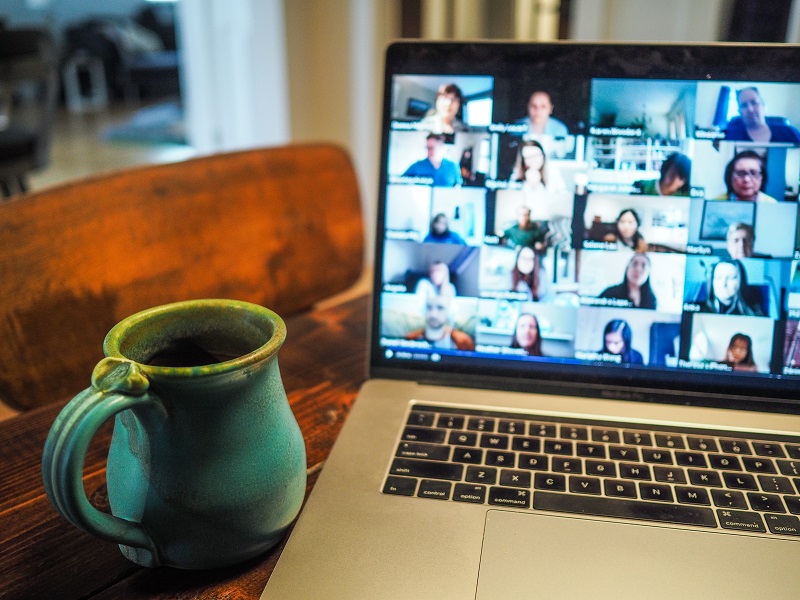 computer on desk showing Zoom meeting 