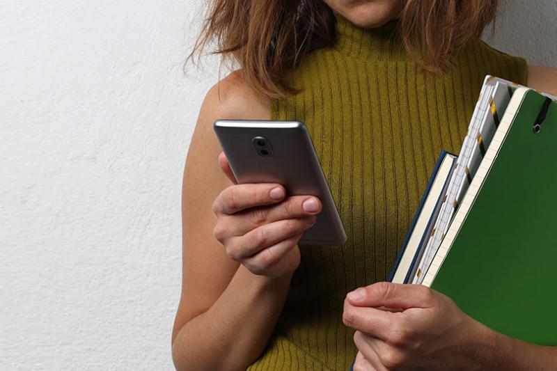 Student downloading apps on their phone.