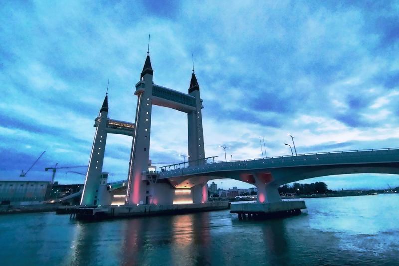 A bridge with two large towers surrounding it. A cloudy, low-light day.