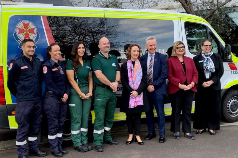 VU Vice-Chancellor Adam Shoemaker with Minister for Ambulance Services Gabrielle Williams (centre) with Ambulance Victoria graduates James McKenna and Jade McKenna (left in blue), VU paramedic students Sibel Unalan and Corey Kelly (in green), MP Natalie Suleyman and AV CEO Jane Miller (right)  