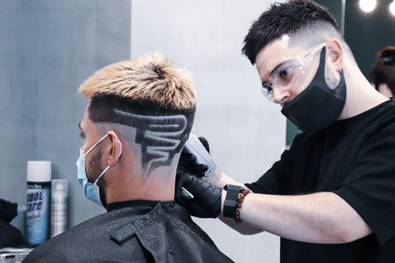 Michael Daskalakis cutting hair in salon