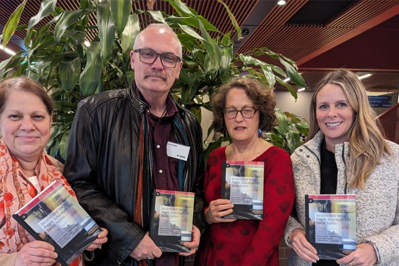 Authors posing with their book.