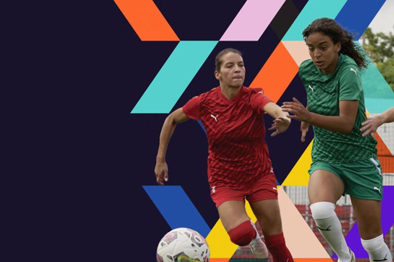 2 female athletes playing soccer